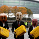 Activists hold jerrycans after spilling fake oil during their performance near the venue where the U.N. climate conference is being held in Glasgow, Scotland.